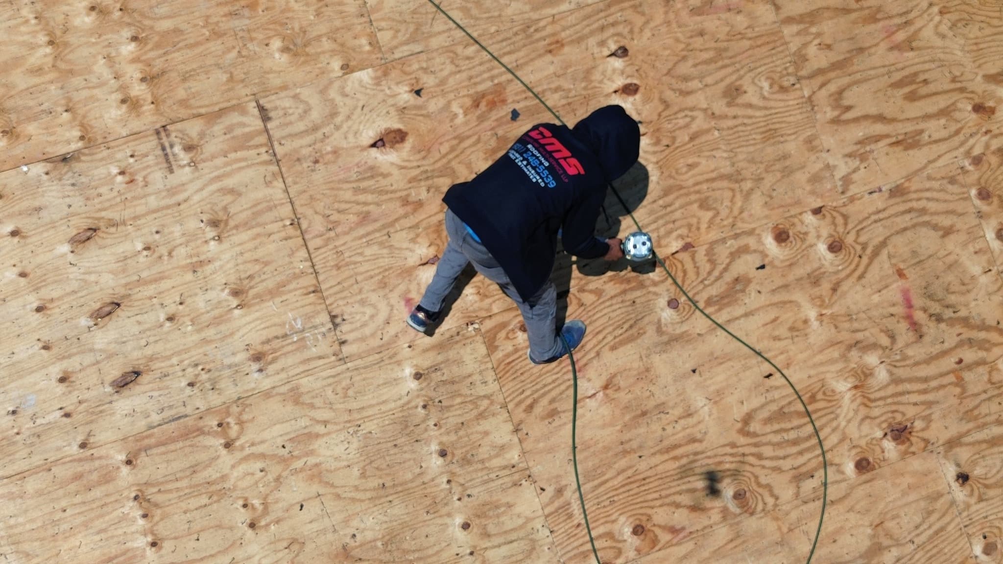 Cumberland Multi-Service crew member working on a roof installation
